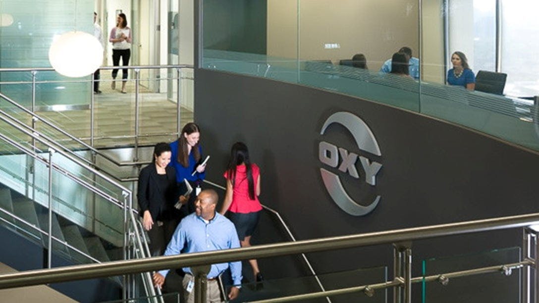 Oxy employees on staircase in office building
